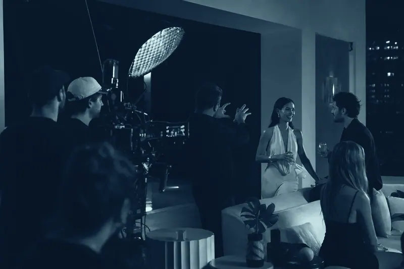 A Mind Miami crew shooting a nightlife set on a rooftop terrace, camera rig and lighting trained on the talent