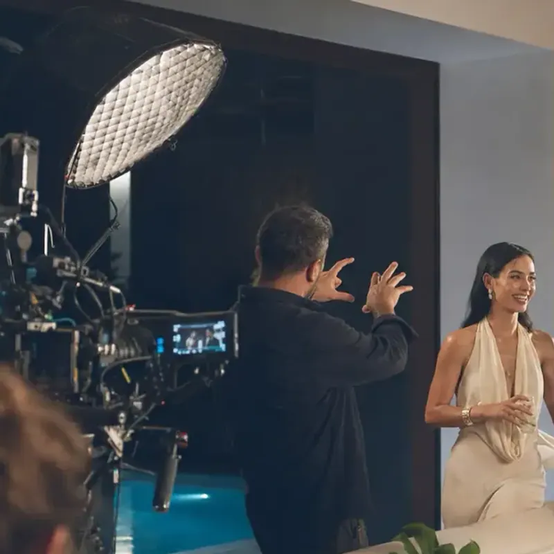 Cinema camera rig on set as the crew directs talent on a rooftop shoot
