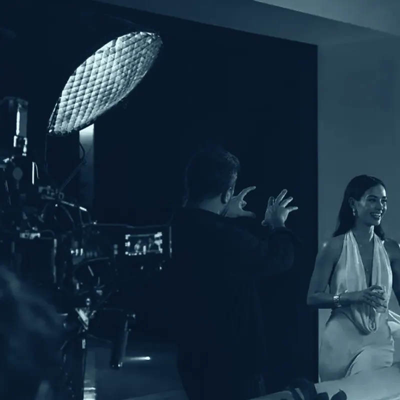 A Mind Miami production crew working a night shoot: camera rig, lighting, and the director calling the take